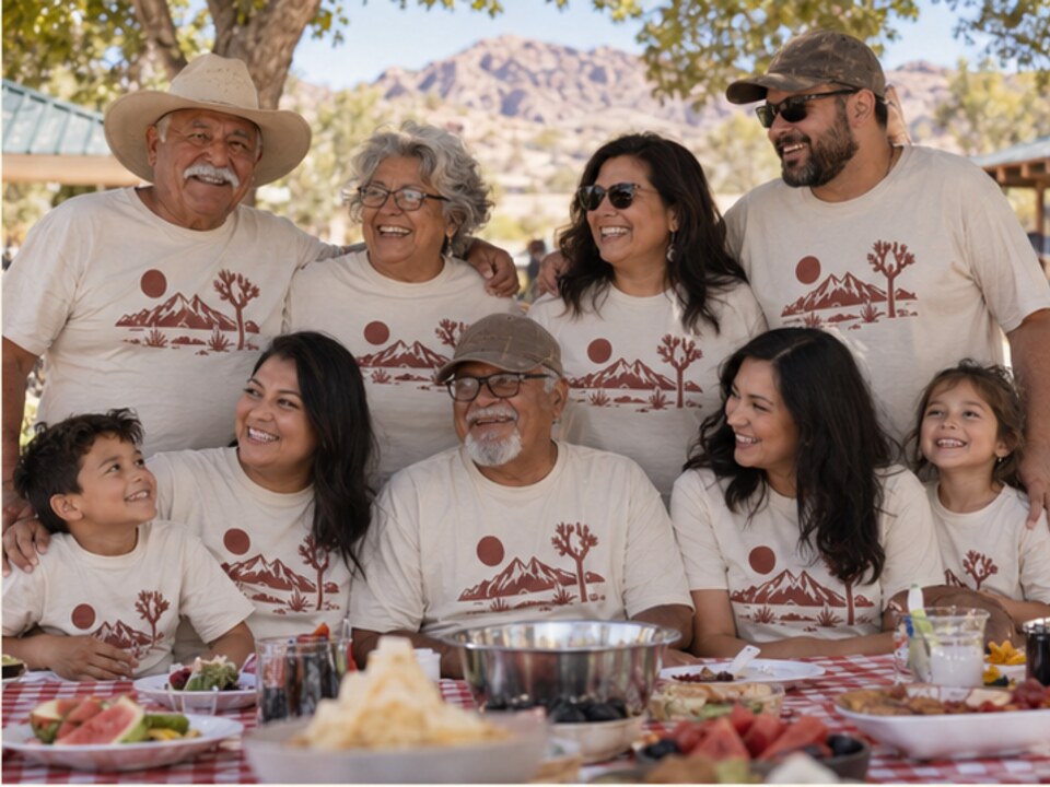 Multigenerational family wearing matching shirts at an outdoor reunion